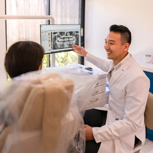 Dr. Peter Lee examining a patient's x-rays